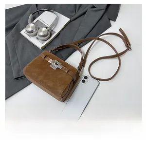 Brown suede tote bag with silver metallic twist lock and chic lifestyle accessories