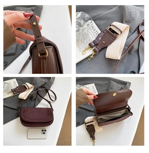 Detail view of brown leather saddle bag showing adjustable straps and inner pocket