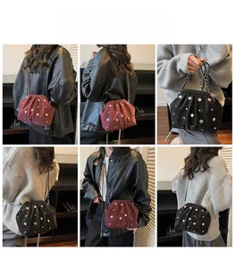 Detailed views of studded chain bags in burgundy and black with pleated metal frame design