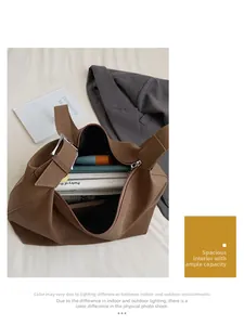 Macro detail of the spacious brown leather tote bag interior with zipper closure