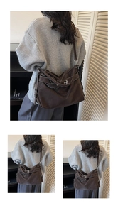Detail of coffee brown retro tote bag with adjustable metal buckle straps on casual outfit