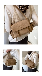 Detail of khaki suede crossbody bag showing the double buckle flap and side pocket design