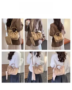 Detail view of beige pleated bucket bag styled as shoulder and crossbody bag for women