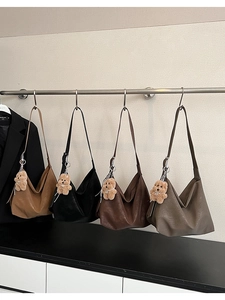 Detail view of large PU leather tote bags in four colors with cute teddy bear pendants