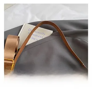 Detail of brown suede Boston bag showing texture and interchangeable shoulder straps