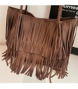 Detail shot of brown suede tote bag featuring bohemian multi-layered fringe tassels