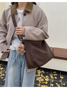 Brown PU leather crossbody tote bag with bear charm shown on a beige winter coat