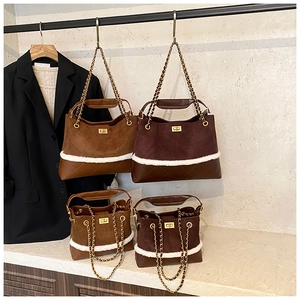 Detail view of suede hobo bags in brown and wine red with diamond quilted leather bottom