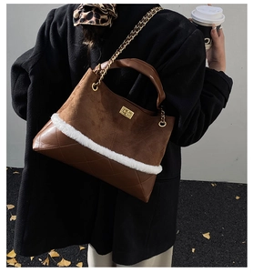 Detail of vintage quilted tote bag with brown suede patchwork and plush faux fur trim