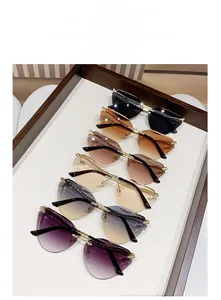 Flat lay of rimless cat-eye sunglasses with snake temple accents in various gradient tints