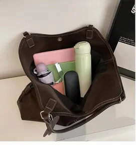 Top view of large brown tote bag showing spacious interior with tablet, bottle and umbrella