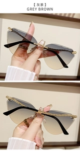 Detail of rimless cat-eye sunglasses featuring golden bamboo texture metal temples