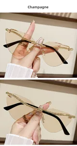 Detail of champagne rimless cat-eye sunglasses with golden bamboo-textured metal temples