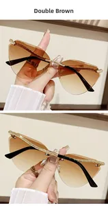 Detail of rimless cat-eye sunglasses with double brown gradient lenses and gold snake legs