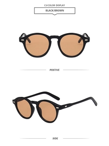 Detail view of vintage round black frame sunglasses with brown lenses and metal rivets