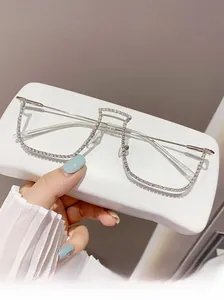 Detailed view of silver cat-eye glasses frame with sparkling rhinestones and clear lenses