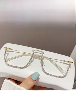 Detailed view of hand-held gold alloy half-frame glasses featuring sparkling AB rhinestones
