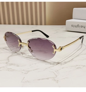 Detail view of rimless oval sunglasses with purple gradient lenses and gold frames