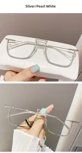 Detail of silver half-rim glasses frames with dense rhinestone inlay and pearl white finish