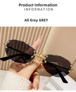 Close-up of rimless oval sunglasses with grey lenses and gold metal nose bridge