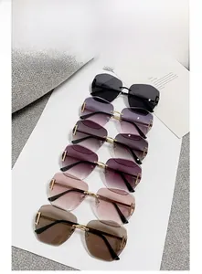 Detail view showing six gradient rimless oversized sunglasses with metal frame accents