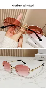 Close-up of vintage rimless oval sunglasses featuring gradient wine red lenses and gold frames