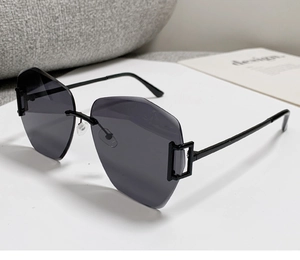 Close-up of geometric rimless sunglasses with black metal temples and square hollow hinges