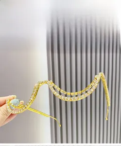 Detailed view of wave-shaped golden double-layer frame with sparkling crystal rhinestones