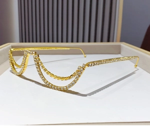 Detailed view of golden semi-rimless glasses frame with rhinestones and double chain design