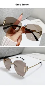 Detailed view of rimless geometric sunglasses with grey brown lenses and gold metal arms