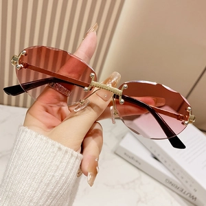 Vintage rimless oval sunglasses with pink gradient cut-edge lenses and gold metal frames