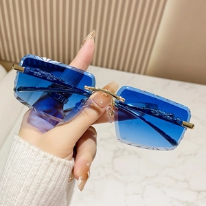 Rimless sunglasses with blue gradient lenses and gold leopard head metal details