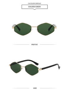 Macro shot of vintage hexagon metal frames with golden finish and deep green lenses