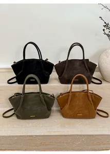 Detail of four matte suede tote bags in black, dark brown, olive, and camel colors