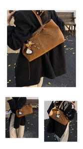 Brown suede tote bag detail with white contrast stitching and leopard heart charm