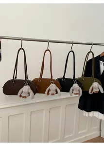 Detailed view of four retro faux leather shoulder bags in coffee, brown, black and green