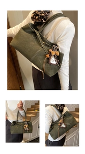 Detail of dark olive green tote bag with white contrast stitching and leopard scarf detail