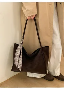Detail of dark brown faux suede tote bag with vintage scarf and long shoulder straps