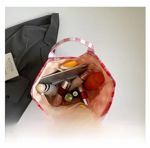 Detailed interior of red checkered canvas tote bag showing large capacity and zipper pocket