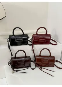 Detailed view of vintage minimalist square handbags in four classic retro colors with top handles