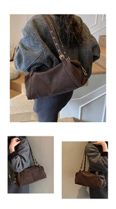Detail view of deep brown vintage cylinder shoulder bag with adjustable eyelet strap
