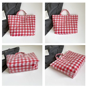 Macro detail of red and white checkered tote bag with waterproof coated surface and text