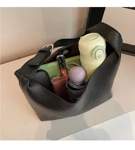 Top view of large black lychee leather bucket bag showing spacious interior with daily items