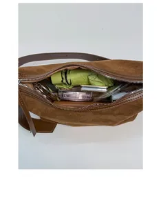 Interior view showing the large capacity of the brown suede handbag with daily essentials