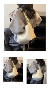 Detail of adjustable leather shoulder strap and lychee grain texture on a cream hobo bag