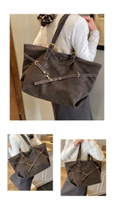 Detail of dark brown tote bag featuring white contrast stitching and metallic buckle