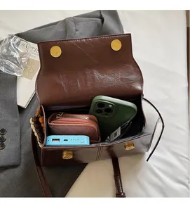 Spacious interior of brown vintage shoulder bag showing storage for phone and wallet