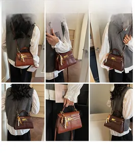 Detail of vintage brown leather trapezoid bag with gold twist lock and bead charm