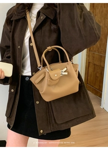 Minimalist retro style khaki bucket bag shown with model for size reference and scale
