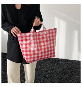 Detail of red and white checkered waterproof tote bag with TOTE BAG print
